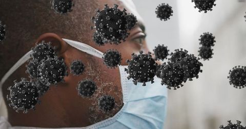 Man Wearing Face Mask with Digital Covid-19 Virus Graphic Overlay