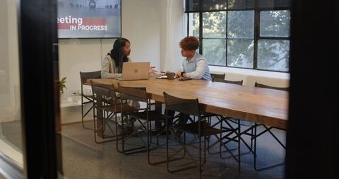 Diverse Team Collaborating on Project in Modern Conference Room