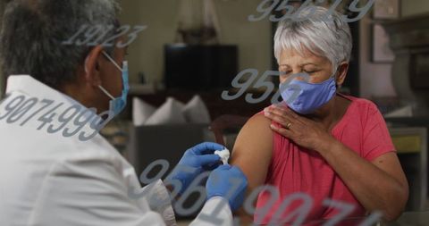 Healthcare Worker Preparing Vaccine for Senior Woman During Pandemic