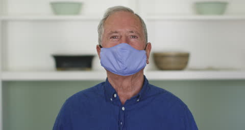 Happy Senior Man Wearing Face Mask for Safety at Home