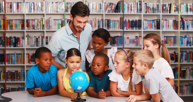 Diverse group of children learning geography with teacher in library - Download Free Stock Images Pikwizard.com