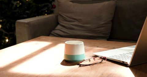 Cozy sunlit workspace with laptop and mug scene