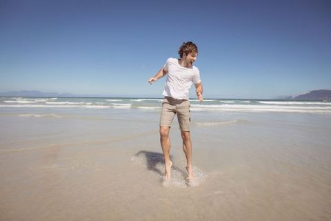 Young man enjoying sunny day at the beach