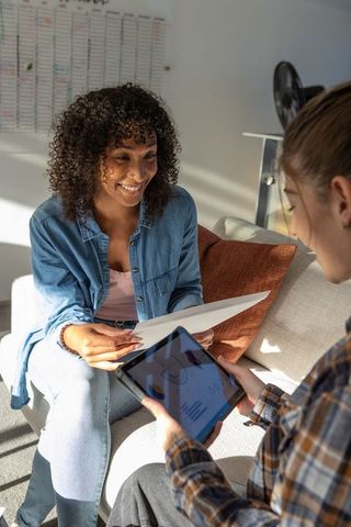 Diverse Female Colleagues Discussing Project Plans in Modern Workspace