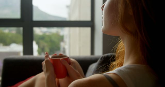 Woman Relaxing with Coffee Mug at Urban Window View - Download Free Stock Images Pikwizard.com