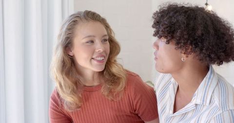 Diverse Couple Communicating Intimately in Cozy Living Room