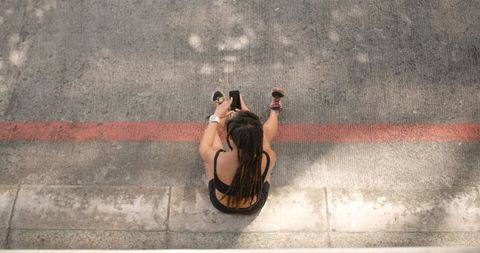 Woman Using Smartphone on Urban Street