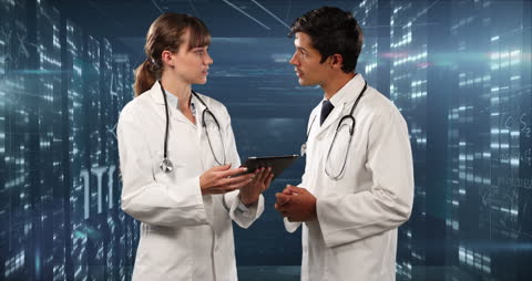 Doctors Using Tablet for Digital Consultation in Futuristic Hospital