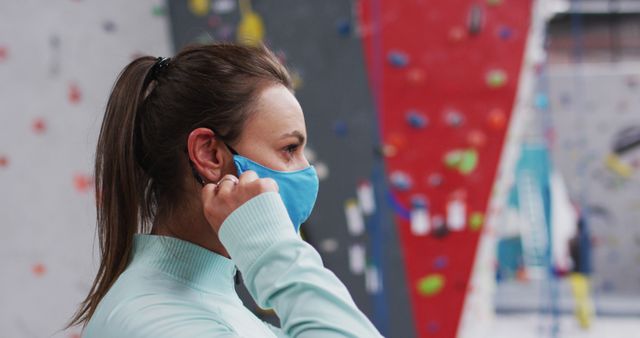 Woman in face mask at indoor climbing gym - Download Free Stock Images Pikwizard.com