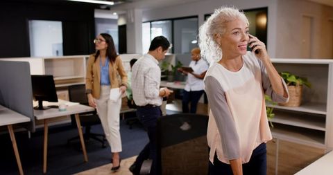 Mature Professional Networking in Modern Open Office