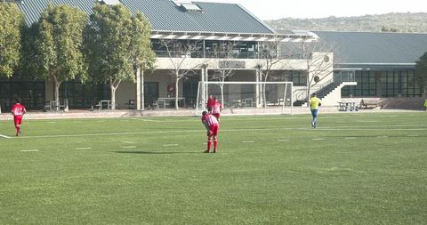 Youth Soccer Team Preparing for Match on School Field