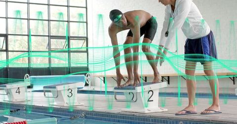 Swimmer preparing dive on starting block with coach and performance analytics overlay