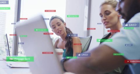 Young professionals collaborating on social media strategy with live notifications in office