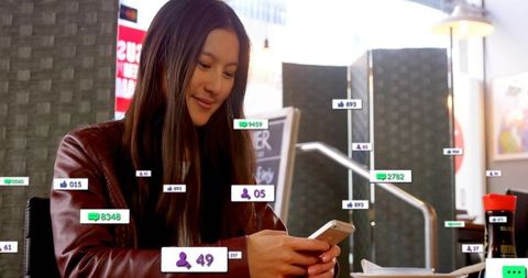Asian woman scrolling smartphone at urban cafe with social media notification overlays
