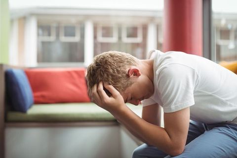 Teenage boy reflecting alone at home in peaceful atmosphere