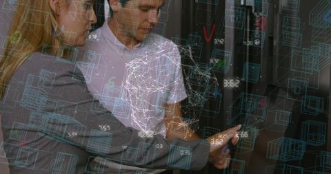 Engineers analyzing data networks in server room