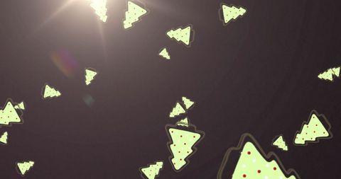 Falling Christmas Tree Icons with Light Flare on Dark Background