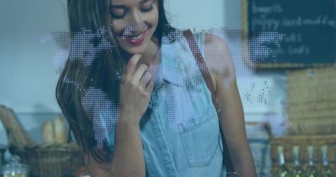 Smiling woman shopping at rustic bakery counter with dotted world map overlay