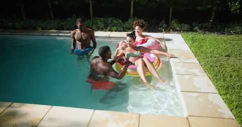 Diverse Friends Relaxing in Pool with Colorful Inflatable Ring