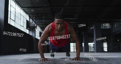 Athlete Performing Push-Ups in Abandoned Building with Floating Numbers