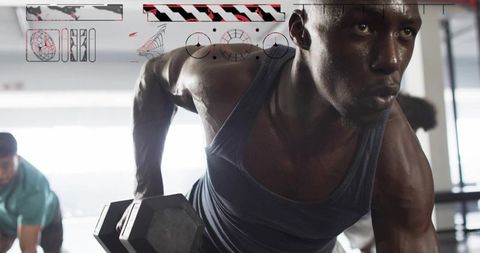Performing One-Arm Dumbbell Row Demonstrating Muscular Strength, Focus and Intensity in Gym