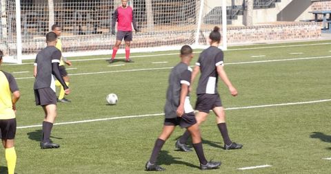 Soccer players practicing on field during training session