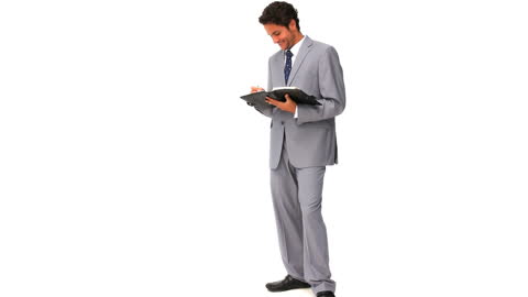 Businessman in Grey Suit Writing on Notepad