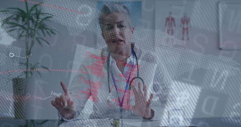 Senior doctor gesturing during augmented reality consultation with holographic data