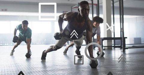 Diverse Team Performing Dynamic Plank Row Workout in Gym