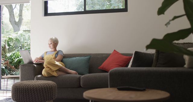 Woman Relaxing on Couch Using Laptop in Modern Living Room - Download Free Stock Images Pikwizard.com