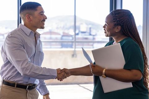 Confident Business Professionals Shaking Hands in Modern Office
