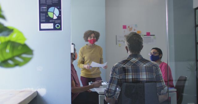 Team brainstorming meeting with masks in modern office during pandemic - Download Free Stock Images Pikwizard.com