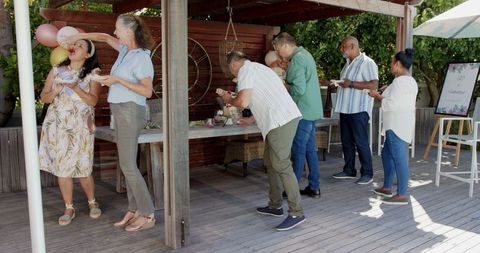 Senior Friends Celebrating Outdoors with Vibrant Dining Experience