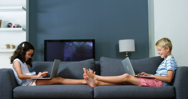 Children Relaxing on Sofa Using Laptops - Download Free Stock Images Pikwizard.com