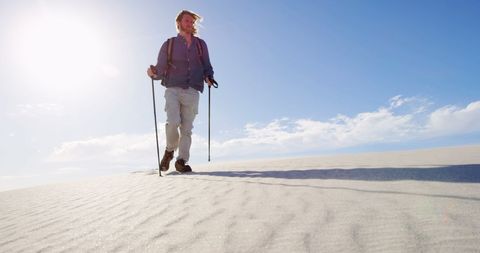 Adventurous Man Hiking in Sunlit Desert Landscape