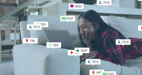 Excited Woman Interacting with Social Media Notifications on Laptop