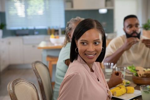 Family enjoying a meal together in a modern kitchen setting