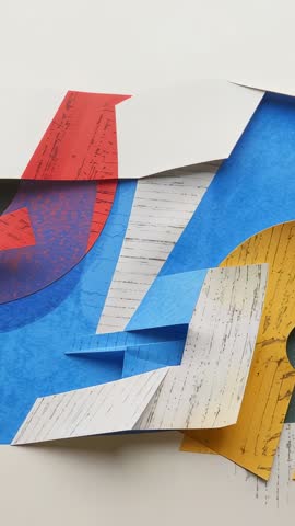 Vertical video panning colorful papercraft collage with mustard arch and geometric pop-up layers