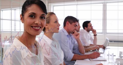 Smiling Businesswoman with Team in Office Meeting