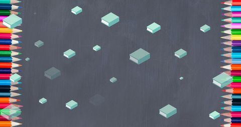 Colorful books and crayons on chalkboard background