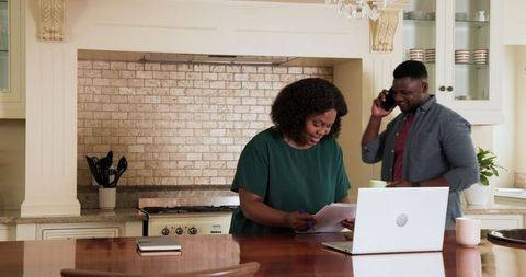 Couple Analyzing Family Finances in Cozy Home Kitchen