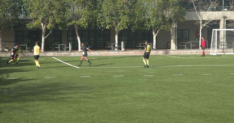 Youth soccer players training with focus and teamwork on outdoor field