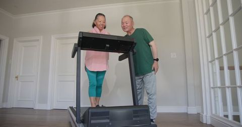 Senior Couple Enjoying Treadmill Exercise at Home Gym