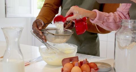 Diverse Couple Baking Together in Sunlit Kitchen