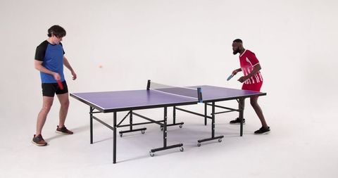 Diverse friends enjoying recreational ping pong match