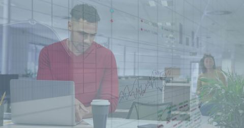 Focused businessman analyzing data with graphs overlay