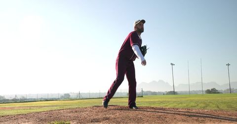 Male Baseball Pitcher in Action on Mound during Game