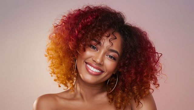 Smiling Woman Showing Curly Ombre Hair with Gradient Background