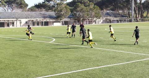 Dynamic Soccer Match on Outdoor Field Showcasing Teamwork