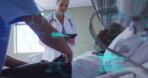 Healthcare team with digital interface in hospital room